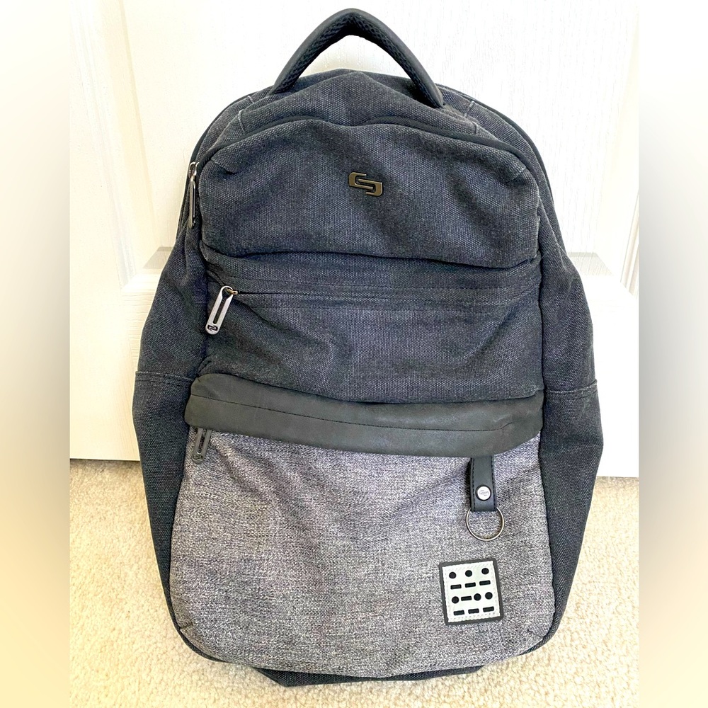 Gray Solo bookbag, lots of pockets, army green interior.